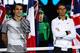 Rafael Nadal, arms folded, looks on as Roger Federer awaits the trophy for winning the 2017 Australian Open.
