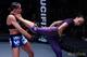 Michelle Waterson lands a spinning back kick to Jessica Penne in their Invicta FC atomweight championship match.