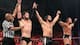 Finn Balor, Seth Rollins and Big Cass celebrate their win.