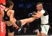 Joanna Jedrzejczyk (left) kicks Jessica Andrade
