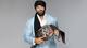 Jinder Mahal posing with a stole WWE title.