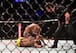 Referee Mario Yamasaki (right) stands over the action between Matthew Lopez (top) and Johnny Eduardo.