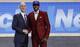 New York's Frank Ntilikina (R) shakes hands with commissioner Adam Silver at the 2017 draft.