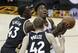 Toronto's Pascal Siakam (43) and Jakob Poeltl (42) defend Cleveland's Iman Shumpert.