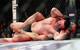 Michael Bisping (foreground) is choked out by Georges St-Pierre