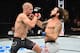 Clay Guida (right) lands an uppercut on Joe Lauzon.