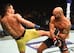 Rafael dos Anjos (left) kicks Robbie Lawler