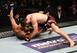 Khabib Nurmagomedov (top) pounds on Edson Barboza (bottom).