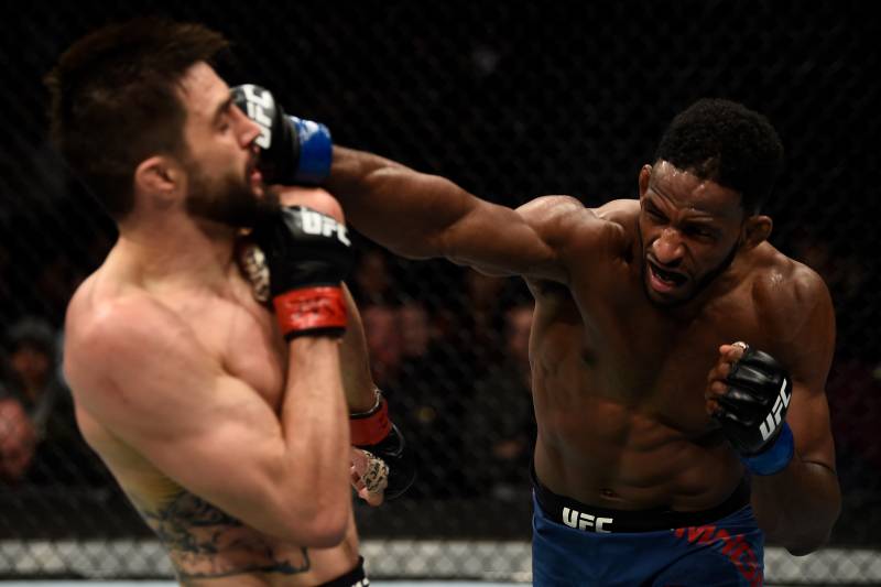 Neil Magny (right) hits Carlos Condit