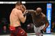 Derrick Lewis (right) hits Marcin Tybura