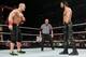 John Cena and Seth Rollins in a WWE ring.