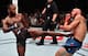 Leon Edwards (left) kicks Donald Cerrone