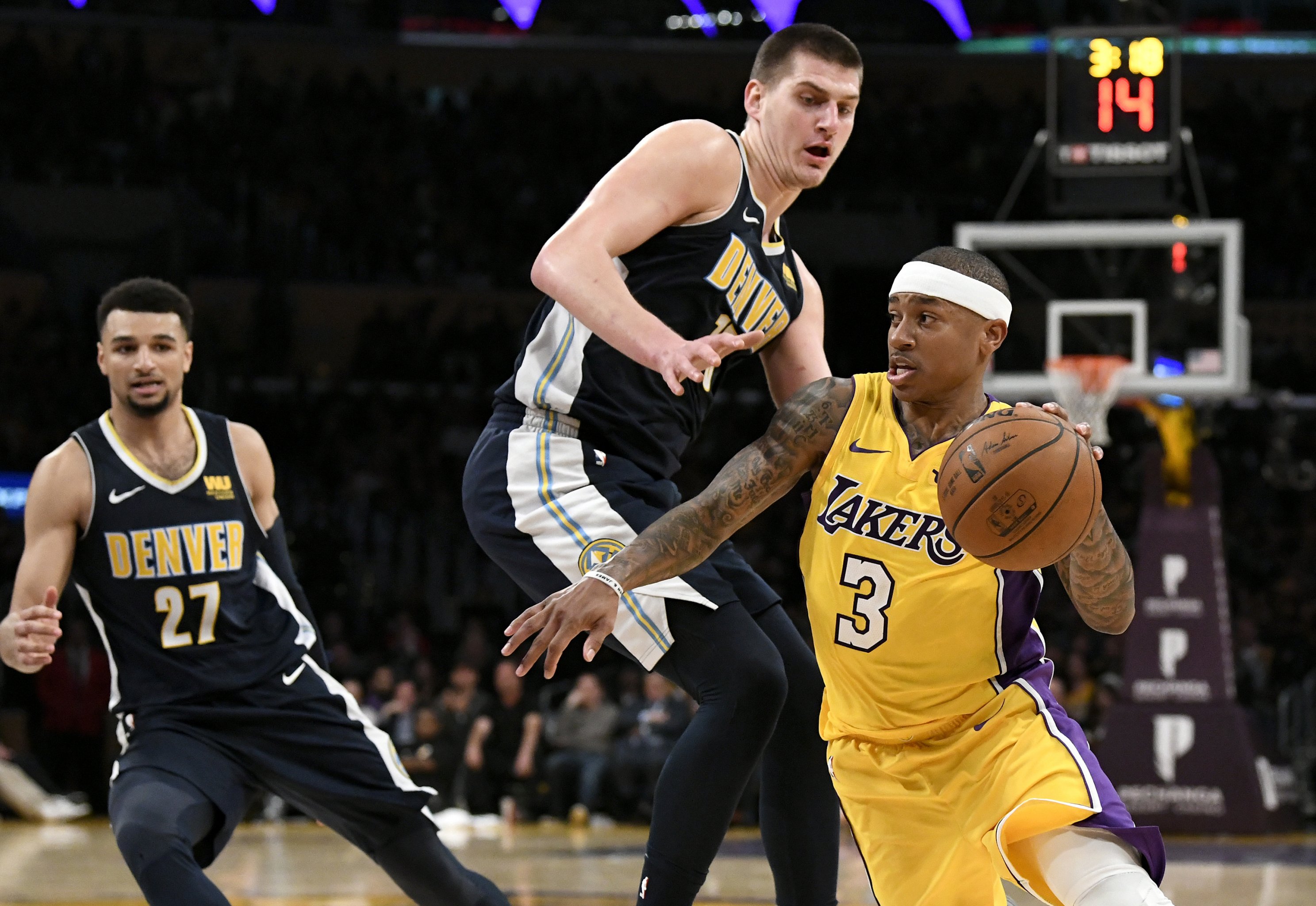 Los Angeles Lakers guard D.J. Augustin (4) controls the ball during the  first half of an NBA basketball game against the Golden State Warriors in  Los Angeles, Saturday, March 5, 2022. (AP