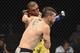 Raoni Barcelos (background) knocks out Kurt Holobaugh.