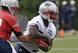 New England Patriots running back Sony Michel takes a handoff from quarterback Tom Brady.