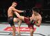 Liu Pingyuan (right) kicks Martin Day en route to a decision victory.