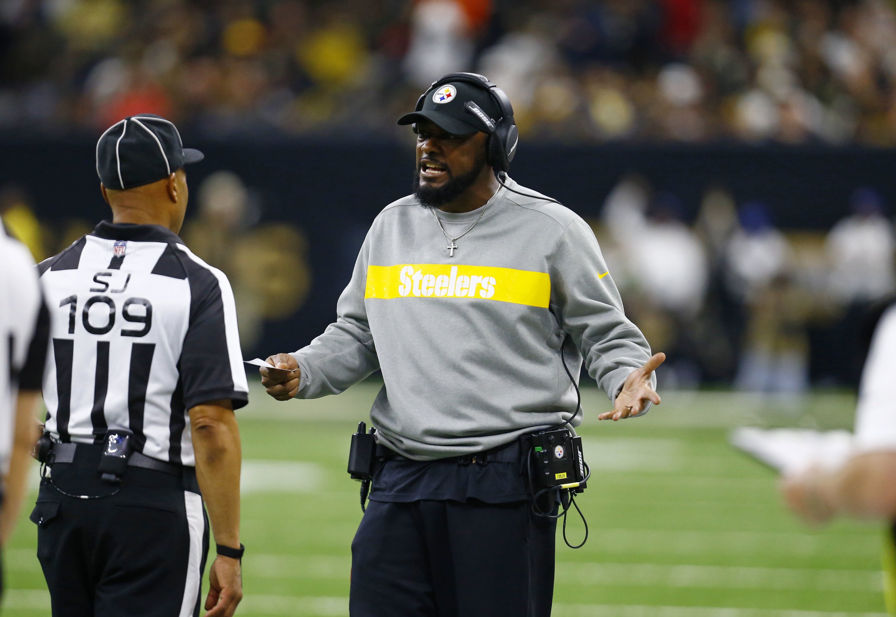 Referee Brad Allen (122) in a 'Crucial Catch' hat during an NFL