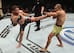 Alexander Volkanovski (left) kicks Jose Aldo.