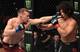 Petr Yan (left) hits John Dodson