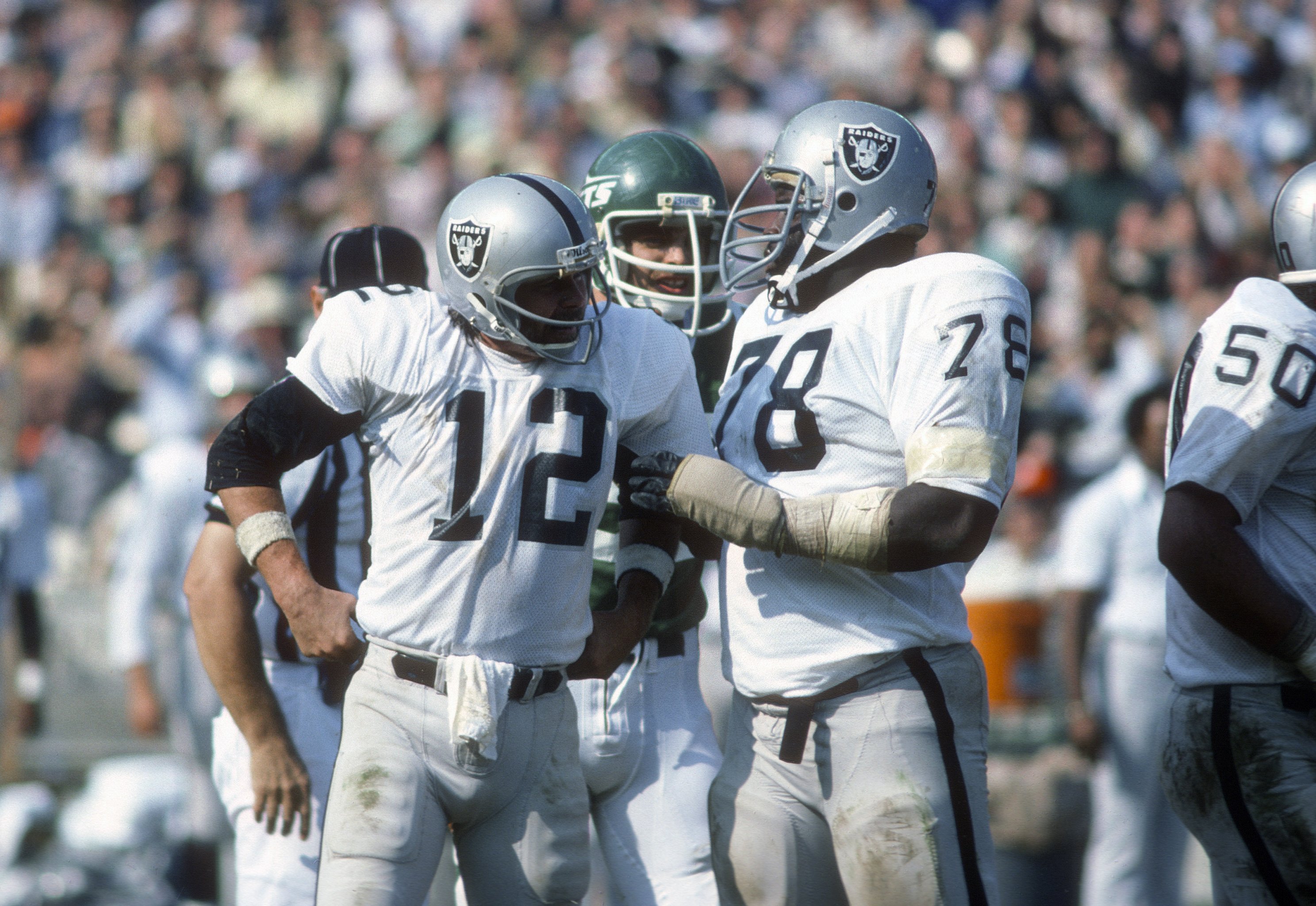 Oakland Raiders quarterback Jim Plunkett takes a snap during the playoff  game between the Cleveland Browns and the Oakland Raiders at Cleveland  Stadium on Jan. 4, 1981. Gene Upshaw is number 63