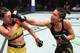 Amanda Ribas (right) punches Mackenzie Dern.