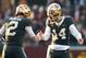 Minnesota's Tanner Morgan (2) and Cole Kramer (14)