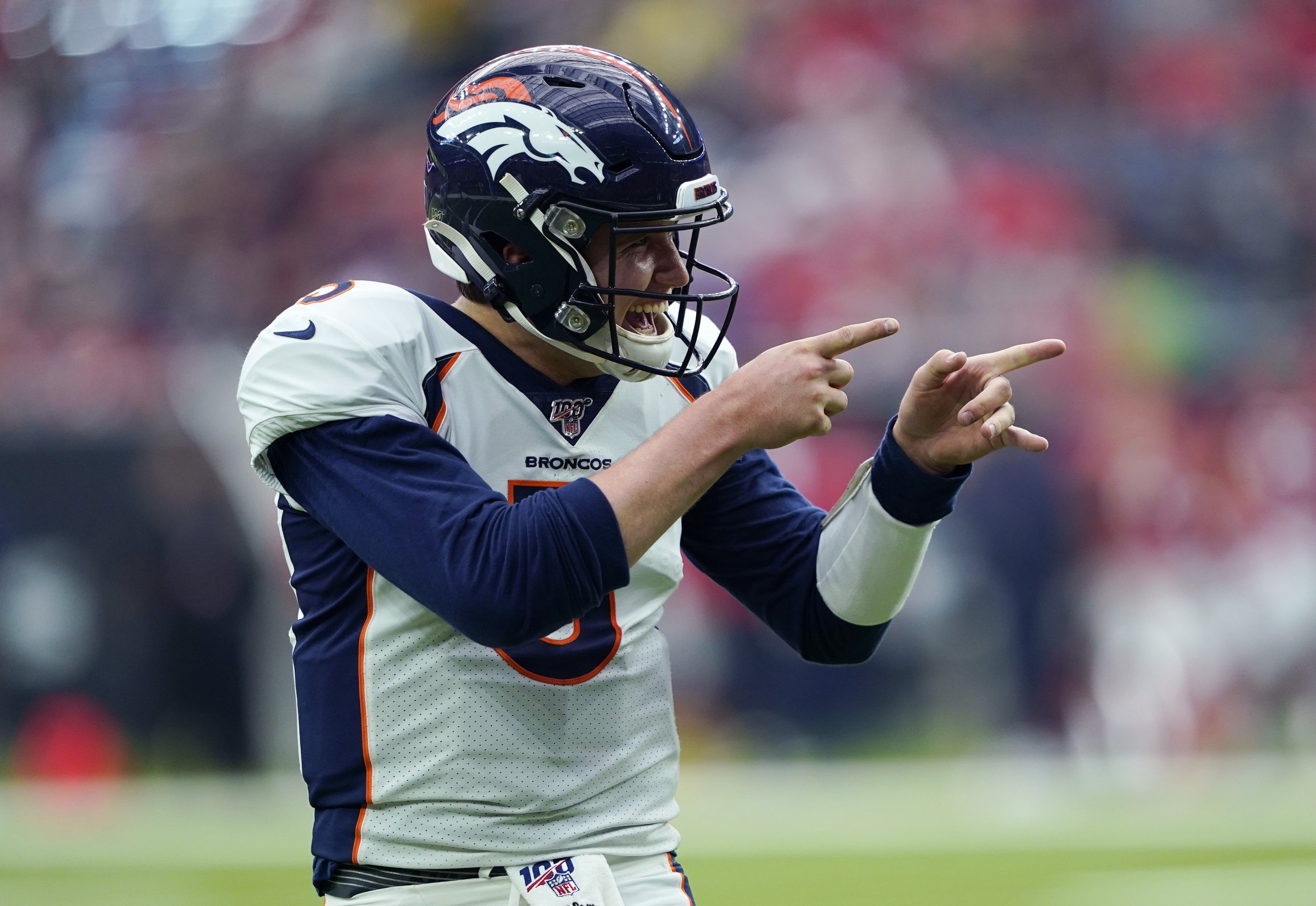 Drew Lock of the Denver Broncos carries the ball ahead of Derrick