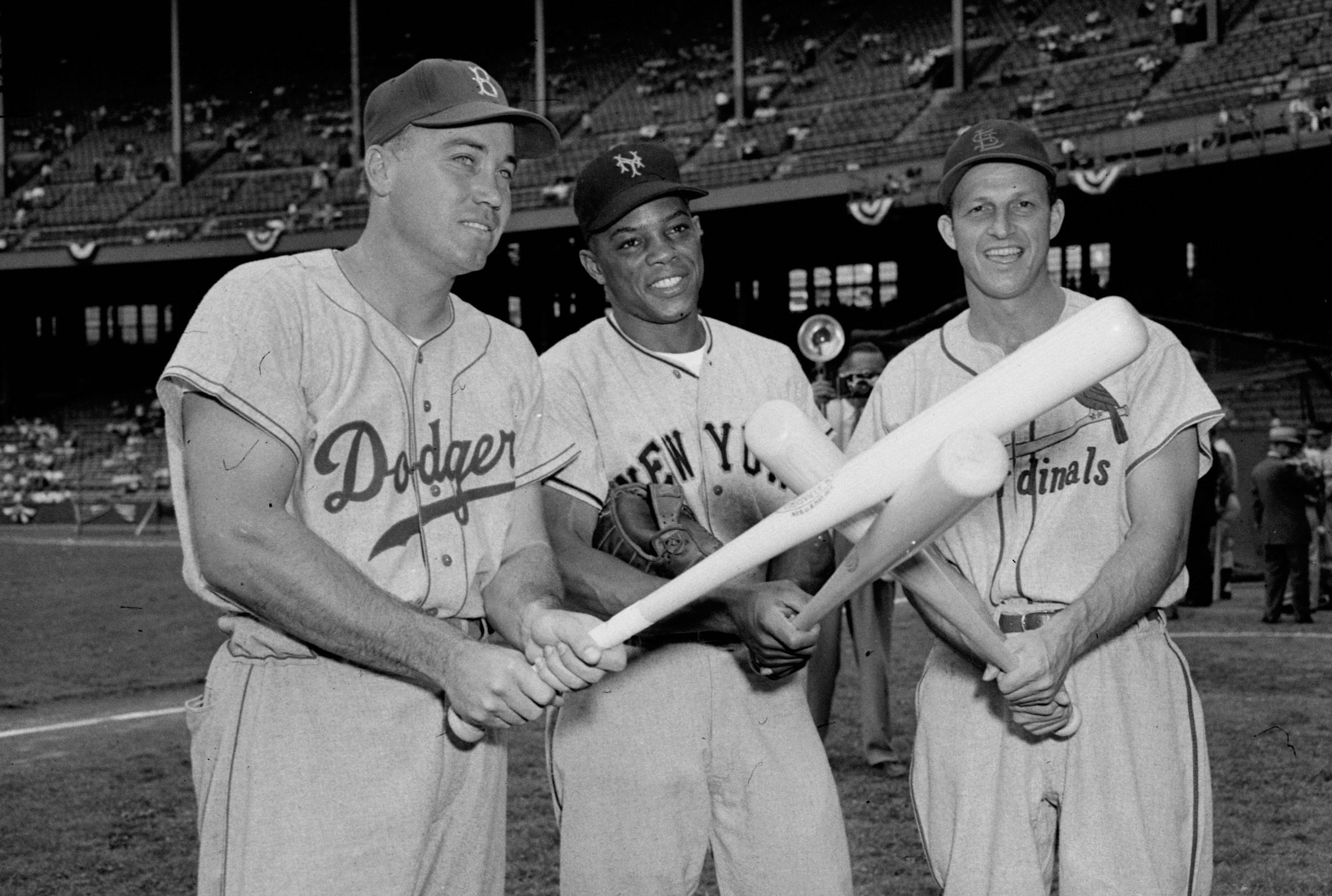 Image of Joe DiMaggio and Harold 'Pee Wee' Reese sign baseballs for