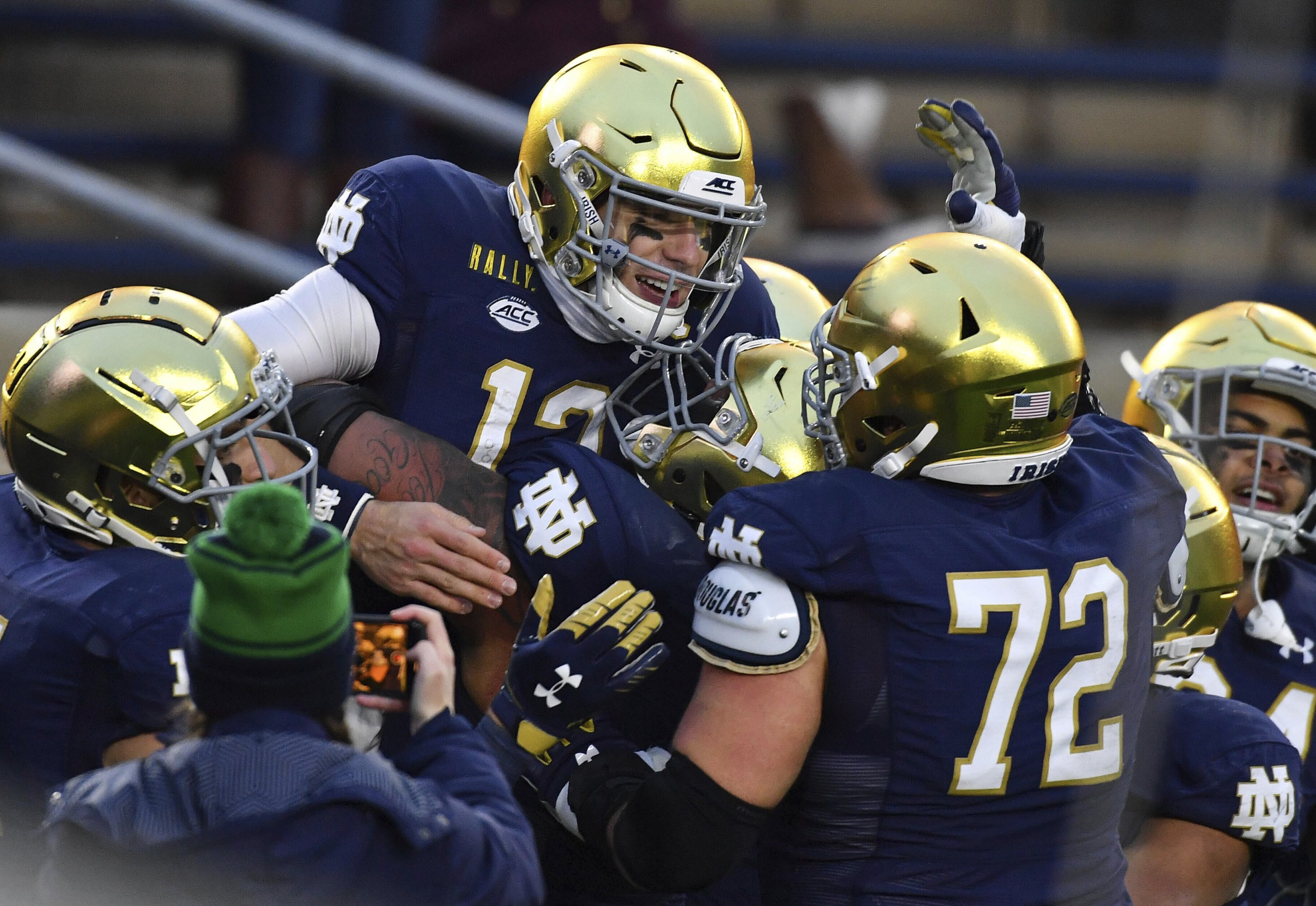 Notre Dame quarterback Ian Book runs out of the pocket in the 2nd