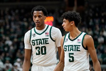 Michigan State's Marcus Bingham (30) and Max Christie (5)